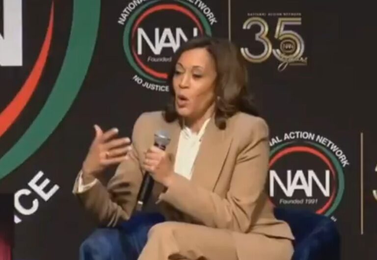 Kamala Harris giving a talk and sitting in a chair