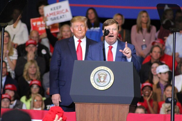 Governor Tate Reeves standing alongside President Trump at a rally