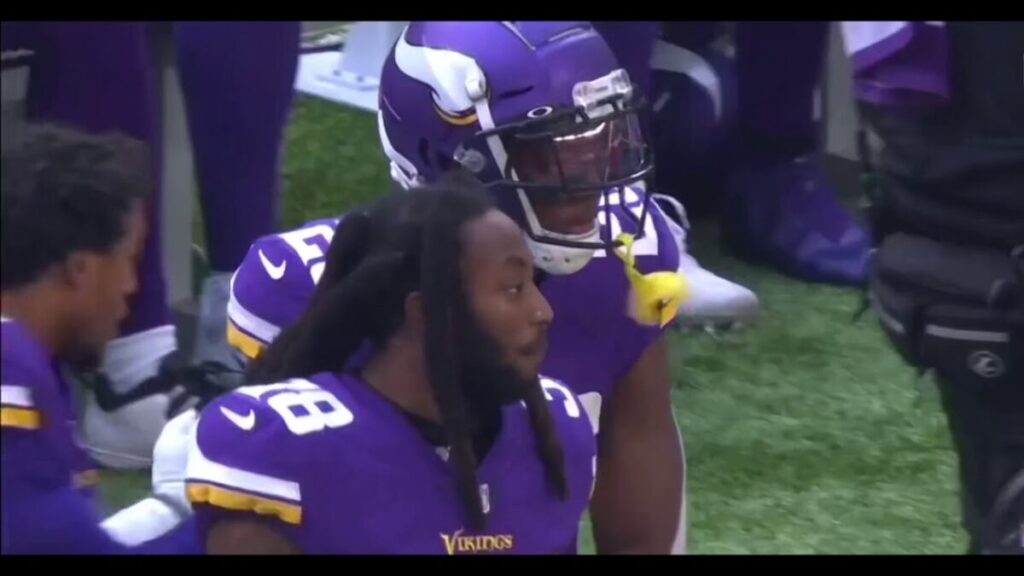 Football players standing on the sideline