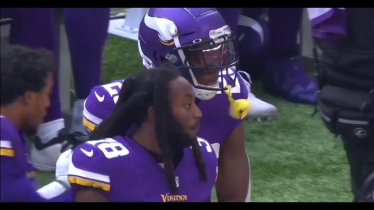Football players standing on the sideline