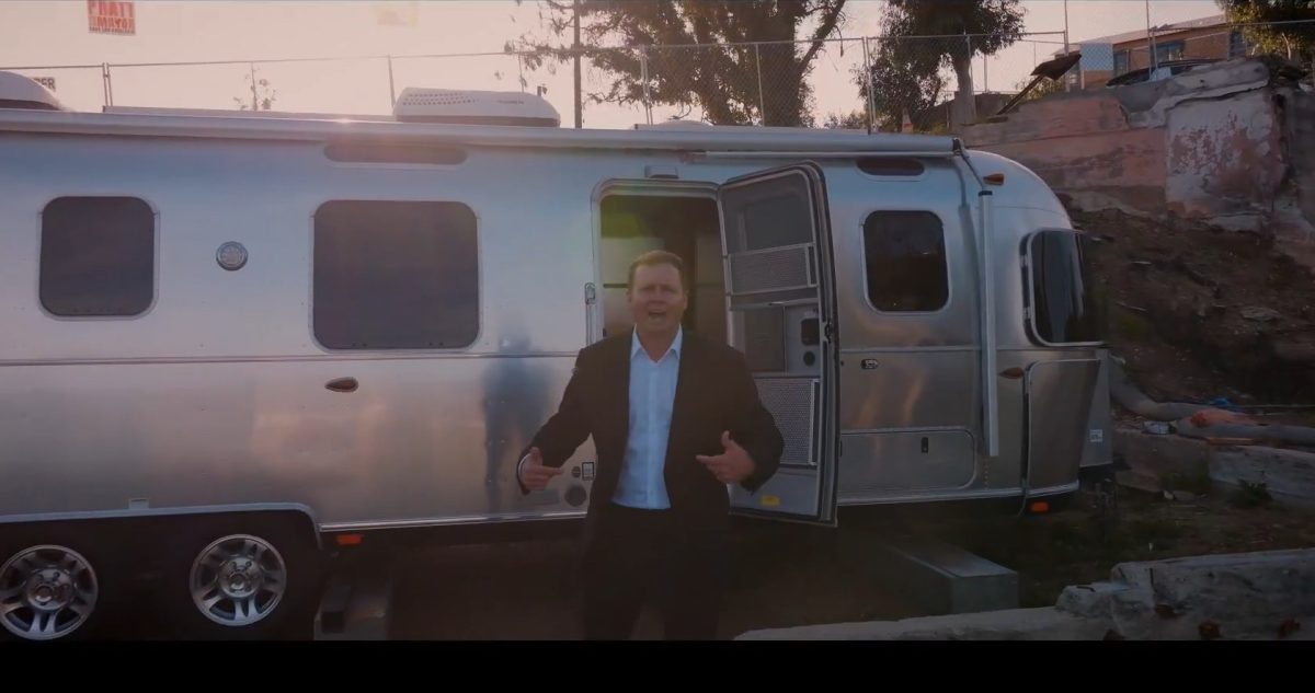 Spencer Pratt standing in front of trailer
