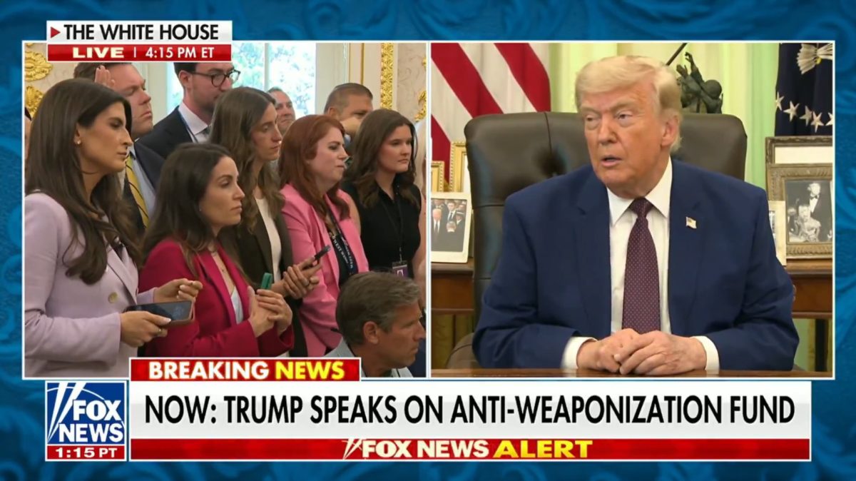 Reporters listening to President Trump speaking