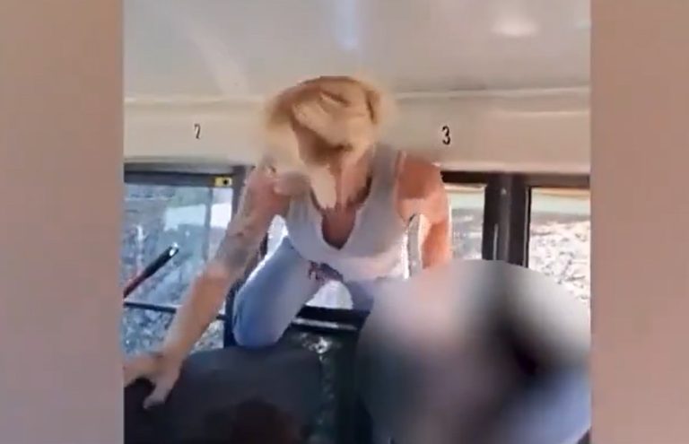 Woman climbing through bus window